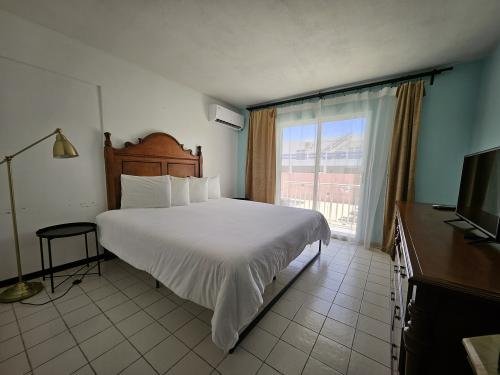 Our Accessible King Bed Room on the ground level offers comfort and ease, overlooking our tranquil pool area with a glimpse of the ocean. A peaceful base for your adults-only Luquillo escape.