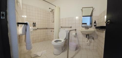 Our Accessible King Bed Room on the ground level offers comfort and ease, overlooking our tranquil pool area with a glimpse of the ocean. A peaceful base for your adults-only Luquillo escape.