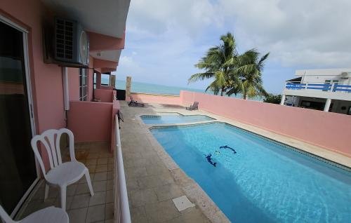 Share a comfortable stay in our Double Full Room (Rm 107) with pool views and a side ocean glimpse from your private balcony, located in Selva Boutique Hotel, Luquillo. Ideal for an adults-only Puerto Rico getaway.