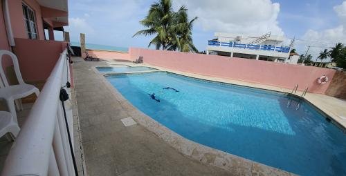 Seek serenity in our King Pool &amp; Ocean Glimpse Room (Rm 105), themed for Humacao, at Selva Boutique Hotel, Luquillo. Offering a king bed, pool views, and a side ocean view from your private balcony. Your peaceful adults-only retreat in Puerto Rico.