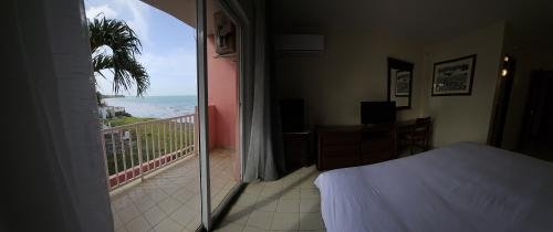 Experience refreshing breezes in our King Side Ocean View Room (Rm 206) at Selva Boutique Hotel, Luquillo. A king bed and private balcony offer a tranquil side ocean view for your adults-only retreat in Puerto Rico.
