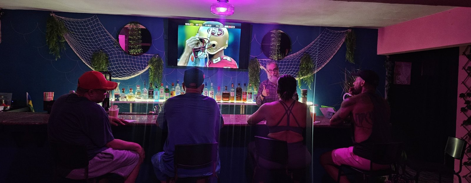 Guests seated at the Selva On The Rocks bar in the evening